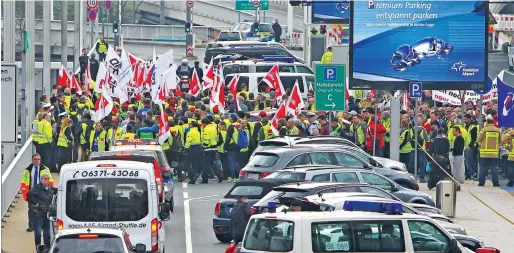  ?? AFP ?? Workers take part in a ‘warning strike’ of German union Verdi at the airport in Frankfurt am Main, Germany, on Tuesday. —