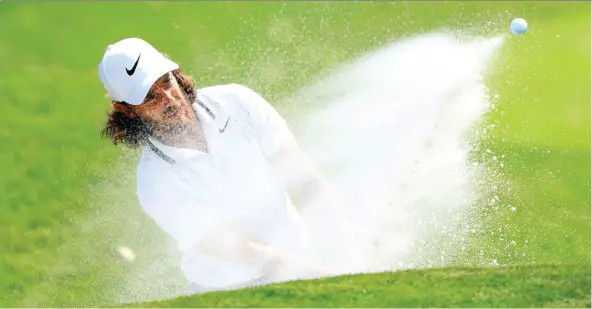  ?? SAM GREENWOOD/GETTY IMAGES ?? Tommy Fleetwood fires from a bunker Thursday at the Players Championsh­ip. The Englishman’s 7-under 65 was good for a share of the lead after one round.