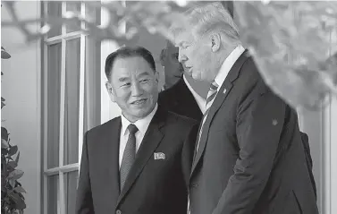  ?? AP Photo/Andrew Harnik ?? ■ President Donald Trump talks with Kim Yong Chol, former North Korean military intelligen­ce chief and one of leader Kim Jong Un’s closest aides, as they walk from their meeting Friday in the Oval Office of the White House in Washington.