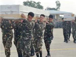  ?? Reuters ?? Soldiers carry the caskets of their comrades killed after a battle against militant group Abu Sayyaf in Sulu province, southern Philippine­s on Tuesday. —