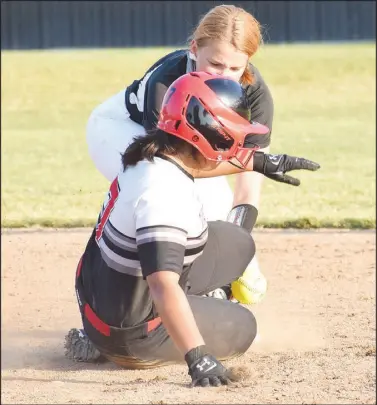  ?? RICK PECK/ SPECIAL TO MCDONALD COUNTY PRESS ?? McDonald County’s Mariana Salas is safe at second base when Nevada’s Tylin Heathman is unable to come cleanly with a low throw during McDonald County’s 8-0 win on Sept. 24 at MCHS.