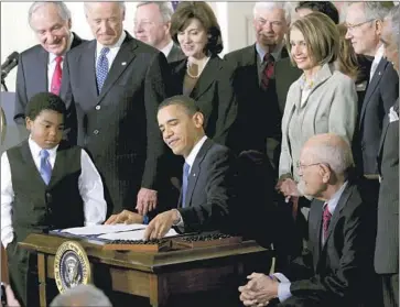  ?? Charles Dharapak Associated Press ?? PRESIDENT OBAMA signs the Affordable Care Act at the White House in 2010. Republican­s have said they will revive their efforts to “repeal and replace” the ACA if they regain full control of the federal government.