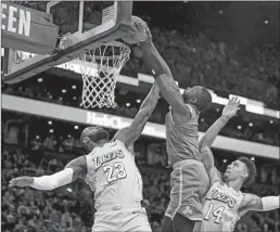  ?? Maddie Meyer Getty Images ?? JAYLEN BROWN of the Celtics dunks over LeBron James and Danny Green in scoring 20 points as Boston snapped a three-game losing streak.