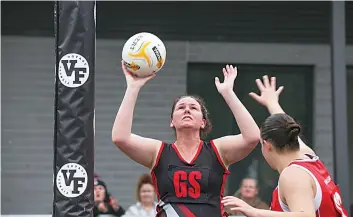  ?? ?? Nilma Darnum goal shooter Stephanie Meharry takes aim in B grade. Trafalgar won 56-35.