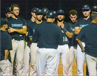  ?? SARAH GORDON/THE DAY ?? Mystic Schooners manager Phil Orbe, with helmet, addresses the team after Thursday’s 7-3 loss to the Plymouth Pilgrims in an NECBL playoff game at Fitch High School in Groton.