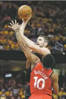  ??  ?? The Cavaliers’ Kevin Love shoots over the Raptors’ DeMar DeRozan. Love finished with 23 points.