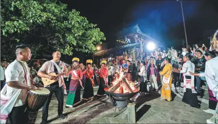  ?? HU CHAO / XINHUA ?? People celebrate around a bonfire in Wengji village of Pu’er, Yunnan province, in September, after the cultural landscape of tea forests there was listed as a World Heritage Site.