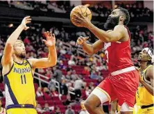  ?? David J. Phillip / Associated Press ?? Rockets guard James Harden, center, shoots over the Pacers' Domantas Sabonis to score two of his game-high 44 points.