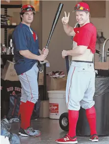  ?? STAFF PHOTO BY MATT STONE ?? DRESSED FOR SUCCESS: Brock Holt gives the peace sign as he and Andrew Benintendi try on belts before a workout yesterday at JetBlue Park in Fort Myers.