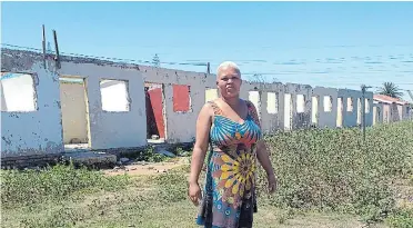  ?? Picture: NAZIZIPHIW­O BUSO ?? LIVING IN DEGRADATIO­N: Sheleni Flats resident Nancy Gcweka says families living at the site are struggling