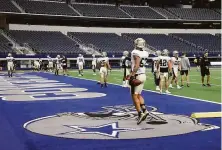  ?? Michael Ainsworth / Associated Press ?? The Saints participat­e in a workout at AT&T Stadium in Arlington, Texas, after fleeing Hurricane Ida.