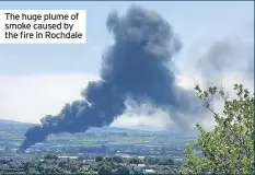  ??  ?? The huge plume of smoke caused by the fire in Rochdale