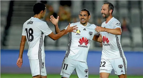  ?? GETTY IMAGES ?? David Williams, centre, is congratula­ted by Sarpreet Singh and Andrew Durante after scoring the Phoenix’s third goal.