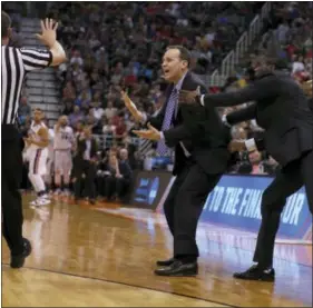  ?? GEORGE FREY — THE ASSOCIATED PRESS ?? Northweste­rn head coach Chris Collins is held back by an assistant coach after receiving a technical foul during the second half against Gonzaga in the NCAA Tournament on Saturday.