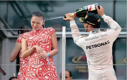  ?? PICTURE: GETTY IMAGES ?? A champagne shower for podium hostess Lui Siying, courtesy of a triumphant Lewis Hamilton at the Chinese Grand Prix last weekend.