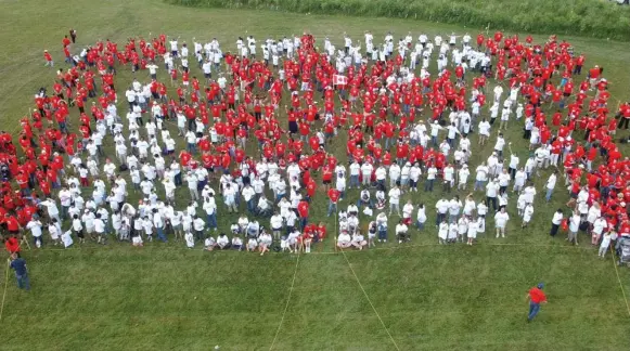  ?? VINCE TALOTTA/TORONTO STAR FILE PHOTO ?? Hundreds of people banded together to form a huge Canadian flag as part of Canada Day celebratio­ns in 2004. The flag was designed by historian and educator George Stanley, chosen in 1964.