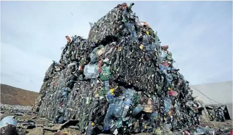  ?? THE ASSOCIATED PRESS FILES ?? Plastic trash is compacted into bales ready for further processing at the waste processing dump on the outskirts of Minsk, Belarus. A new massive study finds that production of plastic and the hard-to-breakdown synthetic waste is soaring in huge...