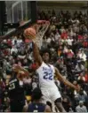  ?? PATRICK HOPKINS — FOR THE NEWSHERALD ?? SPIRE’S Isaiah Jackson dunks against Garfield Heights on Nov. 29 at Euclid.