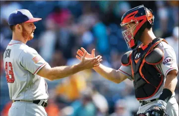  ?? AP PHOTOS BY KEITH SRAKOCIC) ?? San Francisco Giants relief pitcher Sam Dyson, left, is greeted by catcher Buster Posey after striking out Pittsburgh Pirates’ Josh Harrison for the last out Sunday in Pittsburgh.