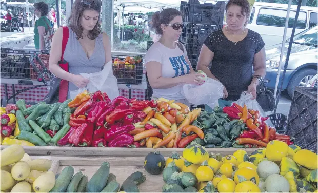  ?? PAUL J. RICHARDS / AFP / GETTY IMAGES ?? In the rush to brag about eating local, the original activist message seems to have gotten lost, writes Claudia McNeilly.