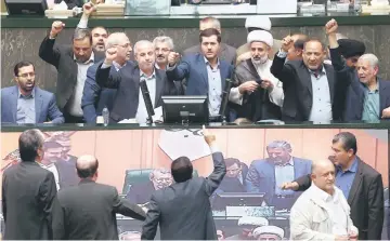  ??  ?? A handout picture provided by the Iranian Parliament shows Iranian MPs chanting anti-US slogans at the parliament in Tehran. — AFP photo