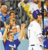  ?? Juan Ocampo / Dodgers ?? Champ Pederson cheers for brother Joc, on deck during an August game at Dodger Stadium.