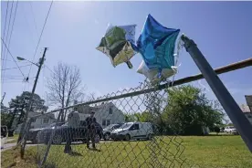 ??  ?? Balloons are seen tied to a fence in Elizabeth City, North Carolina, at the scene where Andrew Brown was killed. Photograph: Gerry Broome/AP