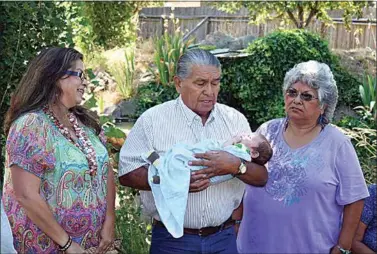  ?? JON HAMMOND / FOR TEHACHAPI NEWS ?? Luther Girado at a baby-naming ceremony for his grandson Jacob. At left is Luther’s daughter Julie Girado Turner and at right is his sister Lucille Girado Hicks.