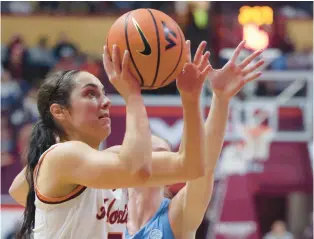  ?? MATT GENTRY/THE ROANOKE TIMES ?? Virginia Tech star guard Georgia Amoore drives while defended by North Carolina’s Lexi Donarski in the first half Sunday at Cassell Coliseum. The Hokies have climbed to fifth in the AP poll.