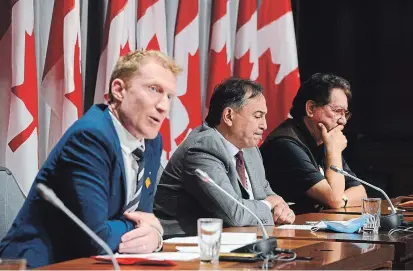  ?? SEAN KILPATRICK THE CANADIAN PRESS ?? Marc Miller, left to right, Perry Bellegarde, and former Grand Chief and elder Mike Mitchell, Mohawk Territory of Akwesasne, sign a protocol agreement to advance First Nations' exercise of jurisdicti­on over child and family services.