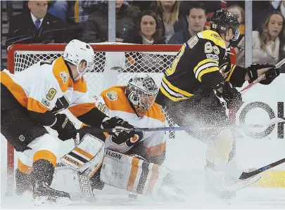  ?? AP PHOTOS ?? BIG AFTERNOON: Brad Marchand (63) scores on Flyers goalie Michal Neuvirth (above) then celebrates with (below from left) Zdeno Chara, Patrice Bergeron and Adam McQuaid in the second period of the Bruins’ 6-3 win yesterday at the Garden. Marchand had...