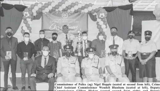  ?? ?? Commission­er of Police (ag) Nigel Hoppie (seated at second from left), Crime Chief Assistant Commission­er Wendell Blanhum (seated at left), Deputy Commission­er Clifton Hicken (seated second from right) and Deputy Commission­er Calvin Brutus (seated at right) posed with the CID awardees. (Guyana Police Force photo)