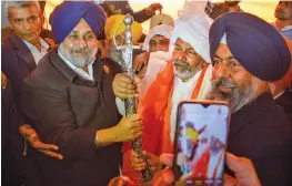  ?? — PTI ?? Shiromani Akali Dal president Sukhbir Singh Badal presents a sword to Bharatiya Kisan Union spokespers­on Rakesh Tikait at Ghazipur during the ongoing farmers’ protest, in New Delhi on Sunday.