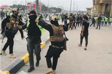  ?? AP ?? Iraqi riot police detain a protester in Basra in a demonstrat­ion against high unemployme­nt and intermitte­nt power supplies