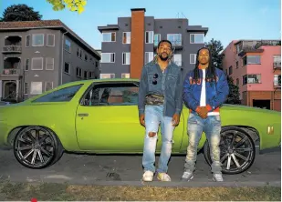  ??  ?? Green light: Cousins Kingdom Chambers (left) and Kuda Mills, both 27, with Mills’ 1973 Chevelle. Says Chambers: “It was Mother's Day, got done with the family, just wanted to ride around. I love the lake. It was really that random. We just come out here when we don't have anything to do specifical­ly and we just ride around.”