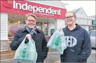  ?? THE GUARDIAN / MAUREEN COULTER ?? Tristan LeClair of Stratford and Jordon Havenga of Cornwall do some lastminute grocery shopping before the winter storm Thursday. LeClair and Havenga picked up some storm chips, milk and cookies and planned to spend the day cuddled up watching Netflix.