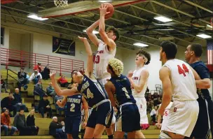  ??  ?? Above, Boyertown’s Aarick Salata (5) drives on Upper Merion’s Lukas Kim (2) and Dom Breece (21) on Thursday. At left, Boyertown’s Kameron Metcalf (30) shoots over Upper Merion’s Collin Bowman (14) and Ty Jones (1).