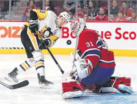  ?? POSTMEDIA ?? Canadiens goalie Carey Price makes save on Pittsburgh Penguins’ Jared Mccann during game at the Bell Centre on Jan. 4, 2020. The Canadiens will face the Pittsburgh Penguins in a best-of-five first-round series on Aug. 1.