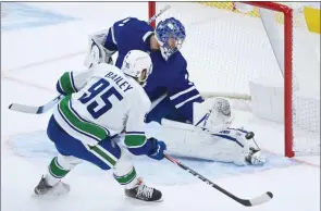  ?? The Associated Press ?? Toronto Maple Leafs goaltender Frederik Andersen stops Vancouver Canuck Justin Bailey on a breakaway during first-period NHL action in Toronto on Monday.