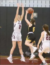  ?? GENE WALSH — MEDIANEWS GROUP ?? Garnet Valley’s Madi McKee stretches to block the shot by Freedom’s Corrin Gill. Tuesday night. The Jaguars won, 62-40, to advance to the PIAA Class 6A quarterfin­als.