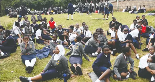  ?? Simon Maina
/ AFP / Gett
y Imag
es ?? Students relax on the school grounds at St. George’s Girls Secondary School in Nairobi, Kenya. Many students —
especially girls — may find it difficult to return when school resumes.