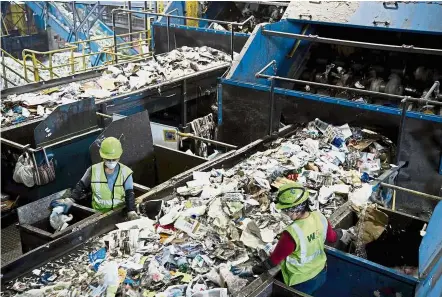  ?? — AFP ?? Rubbish in, rubbish out: Workers sorting recycling material at the Waste Management Material Recovery Facility in Elkridge, Maryland.