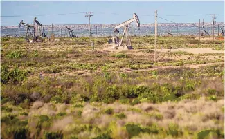  ??  ?? Pump jacks stand scattered throughout the area of Loco Hills between Artesia and Hobb