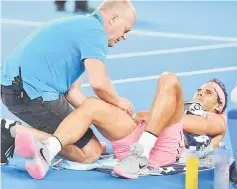  ?? — AFP photo ?? Spain’s Rafael Nadal receives medical attention during their men’s singles quarter-finals match against Croatia’s Marin Cilic on day nine of the Australian Open tennis tournament in Melbourne.