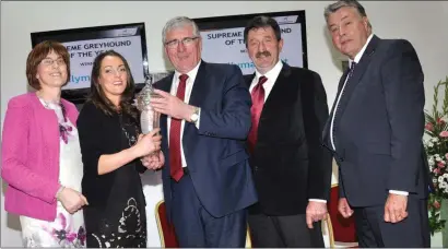  ??  ?? Acting Minister for State Tom Hayes presents the Supreme Greyhound of the Year 2015 award to Kelly Macari, owner of Ballymac Matt, at the National Greyhound Awards hosted in Limerick Greyhound Stadium. Also pictured are Geraldine Larkin, CEO IGB, Phil Meaney, Chairman IGB, and Liam Dowling, trainer of Ballymac Matt.