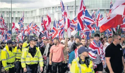  ??  ?? ●●The Britain First march goes past Number One Riverside with a strong police escort