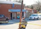  ?? SEAN RAYFORD/AP ?? An officer removes crime scene tape in front of Mac’s Lounge on Sunday in Hartsville, S.C.