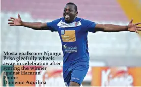  ??  ?? Mosta goalscorer Njongo Priso gleefully wheels away in celebratio­n after scoring the winner against Hamrun Photo: Domenic Aquilina