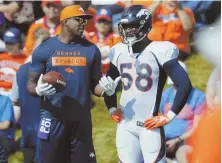  ?? AP PHOTO ?? MEETING OF MIGHTY MINDS: Retired defensive standout DeMarcus Ware (left) confers with Broncos star linebacker Von Miller during Denver training camp yesterday in Englewood, Colo.