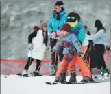  ?? PROVIDED TO CHINA DAILY ?? A coach teaches a child how to ski at a resort in Hangzhou, Zhejiang province, on Dec 23.